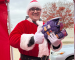 Person dressed as Santa holding pet food