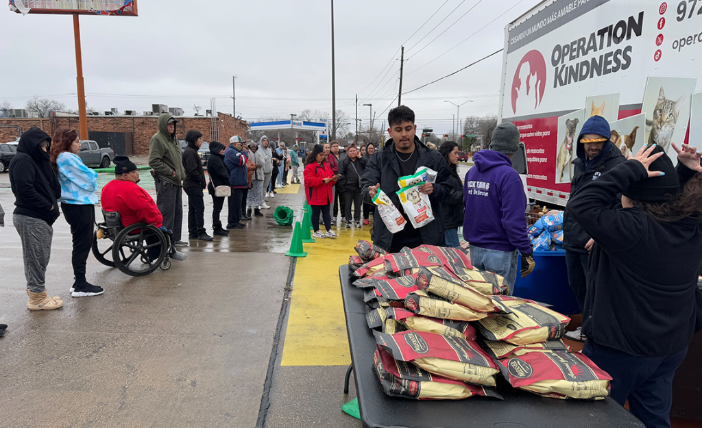 Operation Kindness staff handing out pet food at Southeast Dallas Pet Food Pantry event