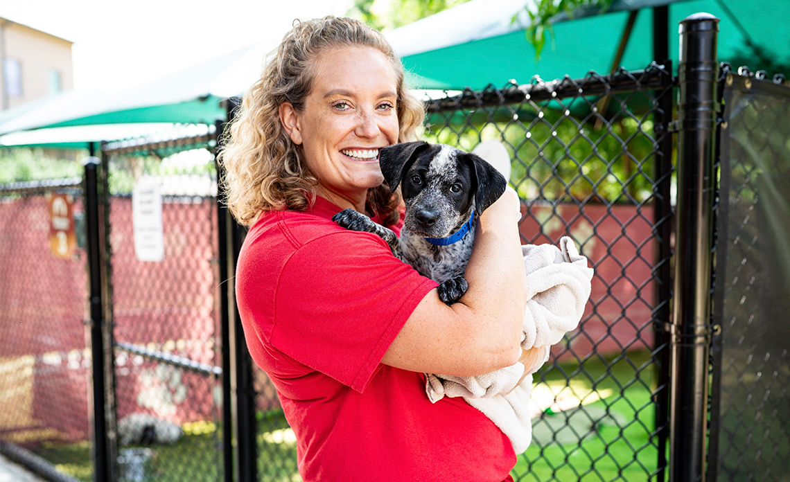 Emily Brooker with an Operation Kindness puppy