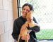 Person smiling while holding puppy