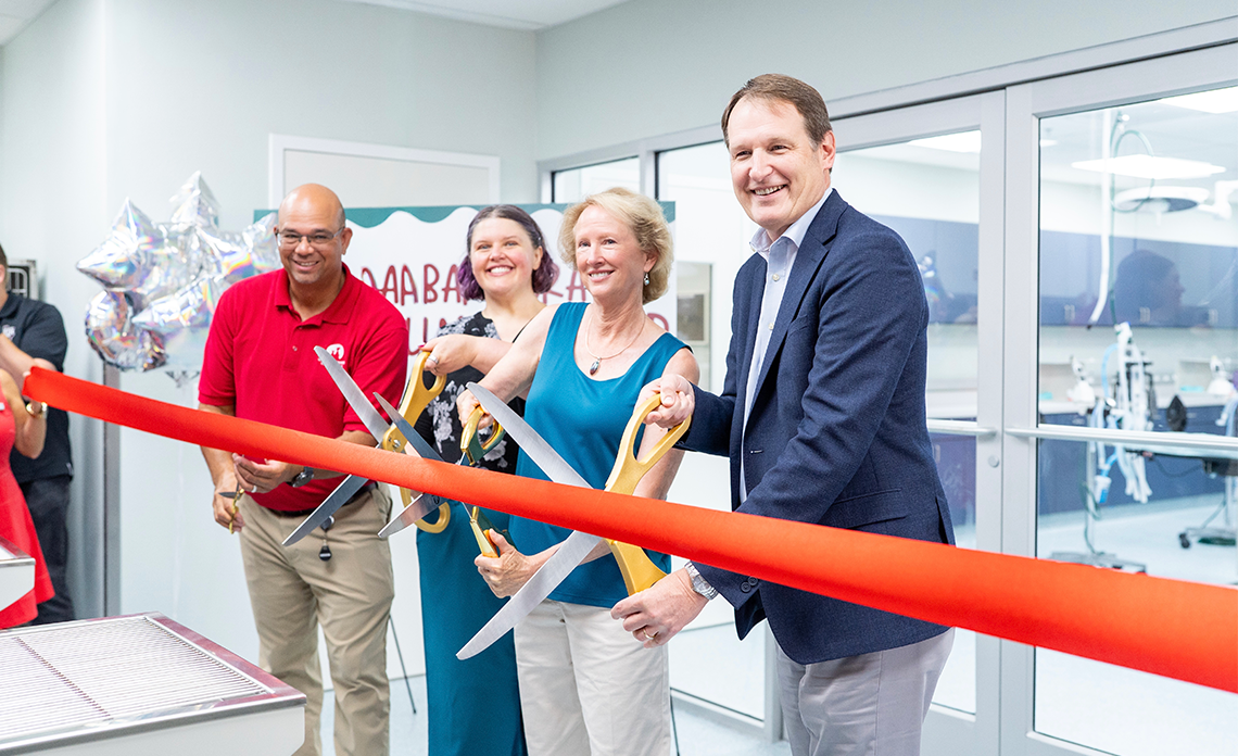 People cutting the ribbon at the VMP ribbon cutting.