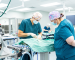 Two veterinarians performing surgery in the VMP