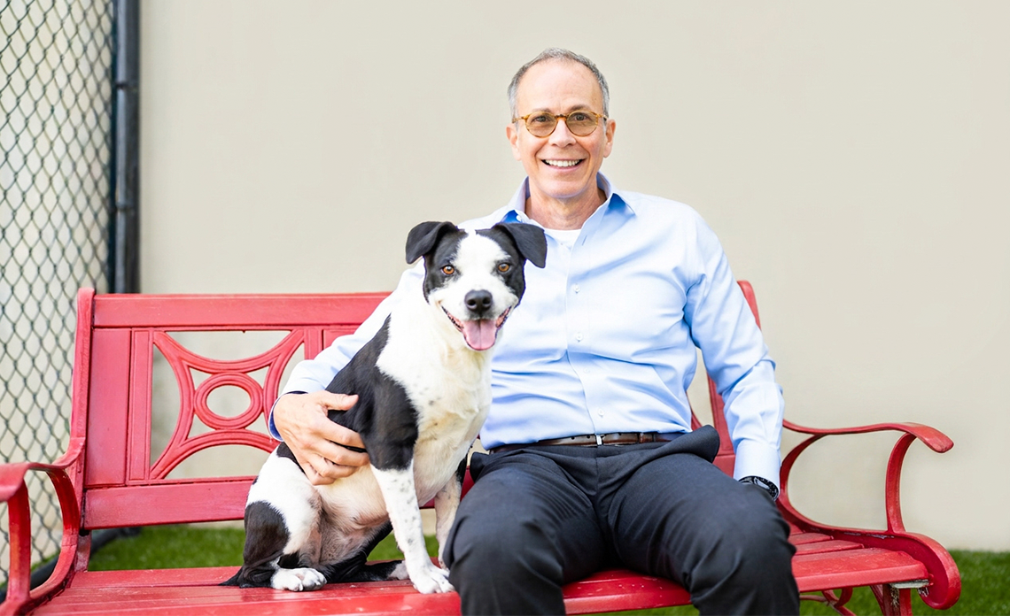 Eric with a black and white dog.