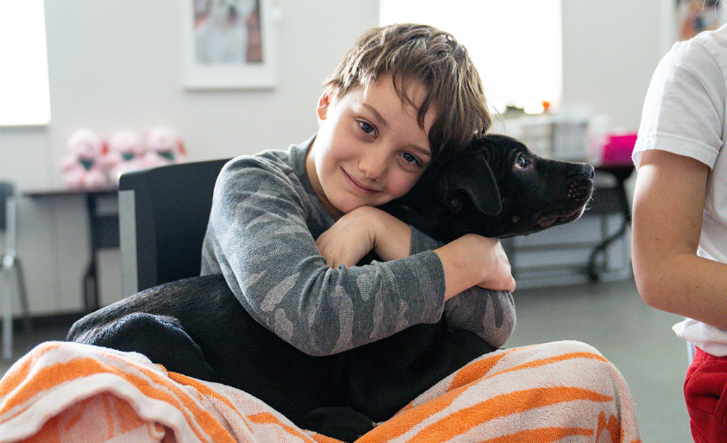 Child hugging a shelter dog